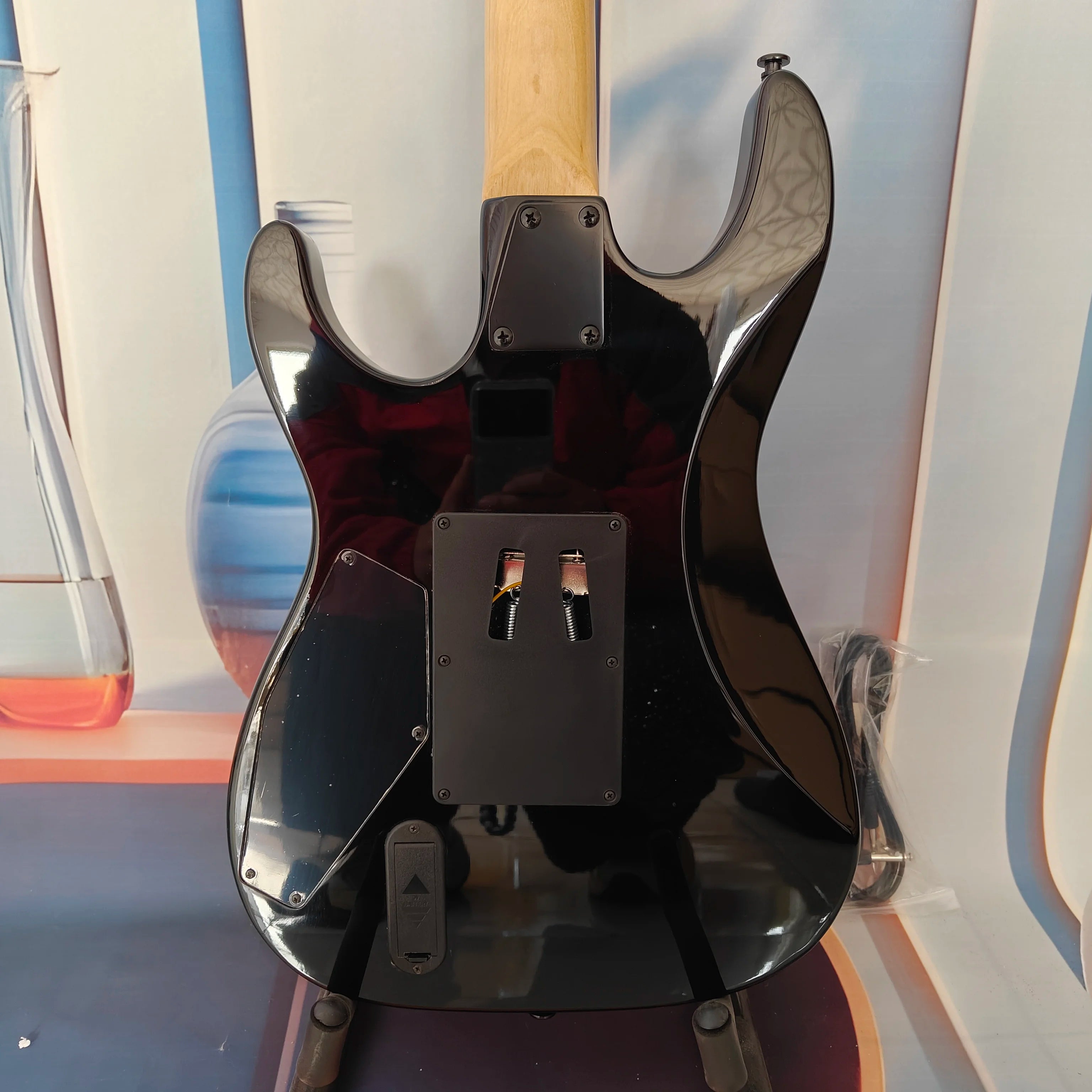 A high-quality acoustic electric guitar with solid wood body, body decals, rock style, right-hand playing and stainless steel fr