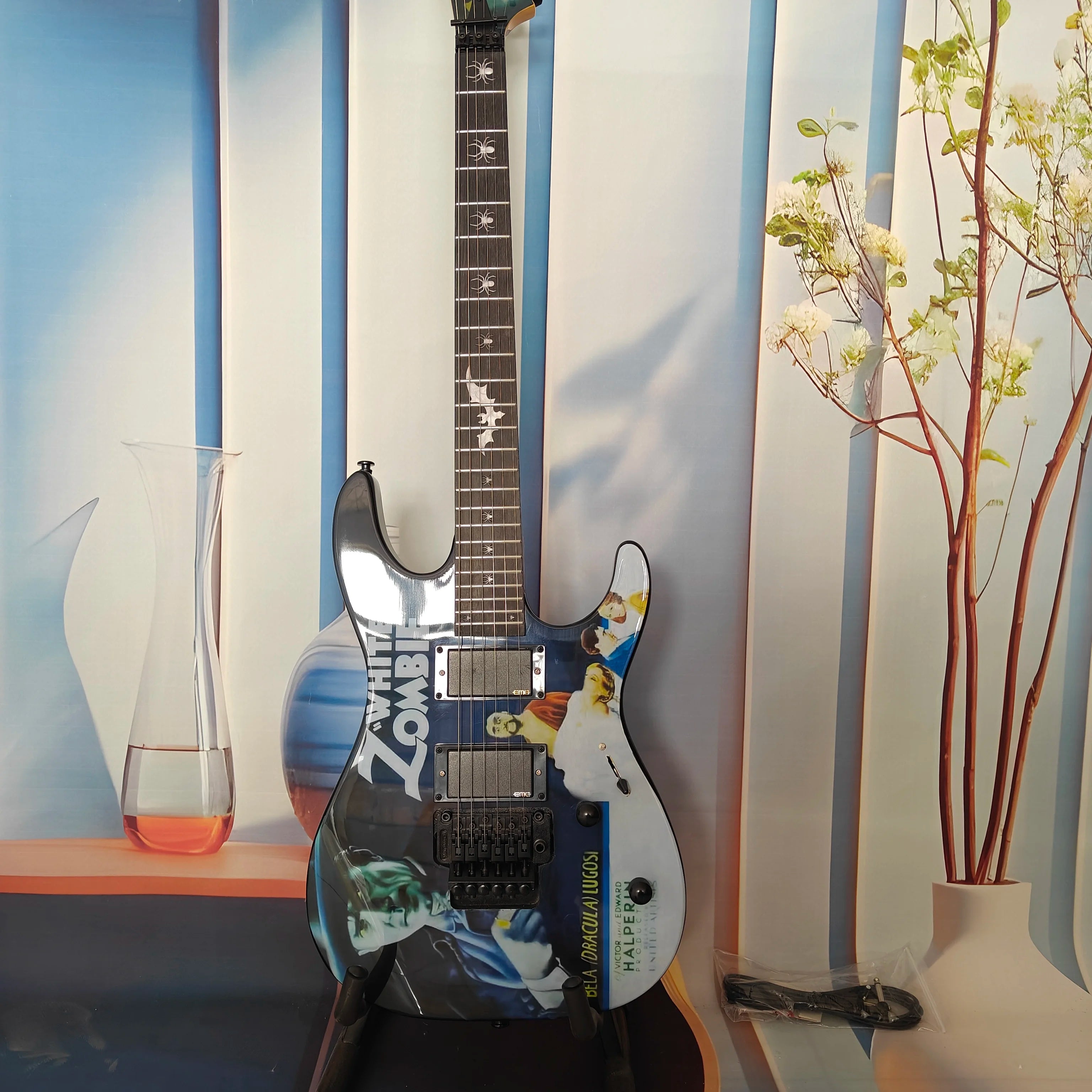 A high-quality acoustic electric guitar with solid wood body, body decals, rock style, right-hand playing and stainless steel fr