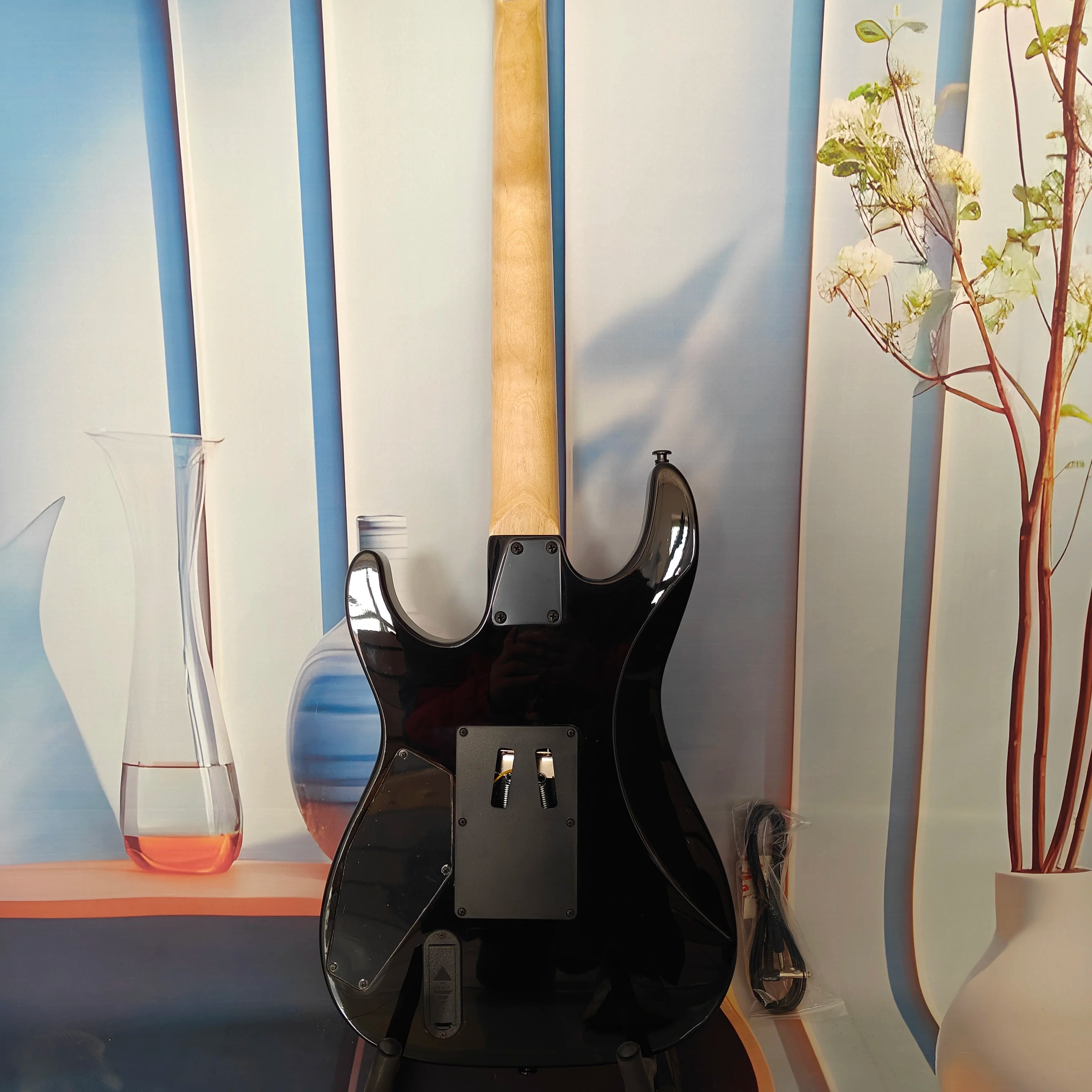 A high-quality acoustic electric guitar with solid wood body, body decals, rock style, right-hand playing and stainless steel fr