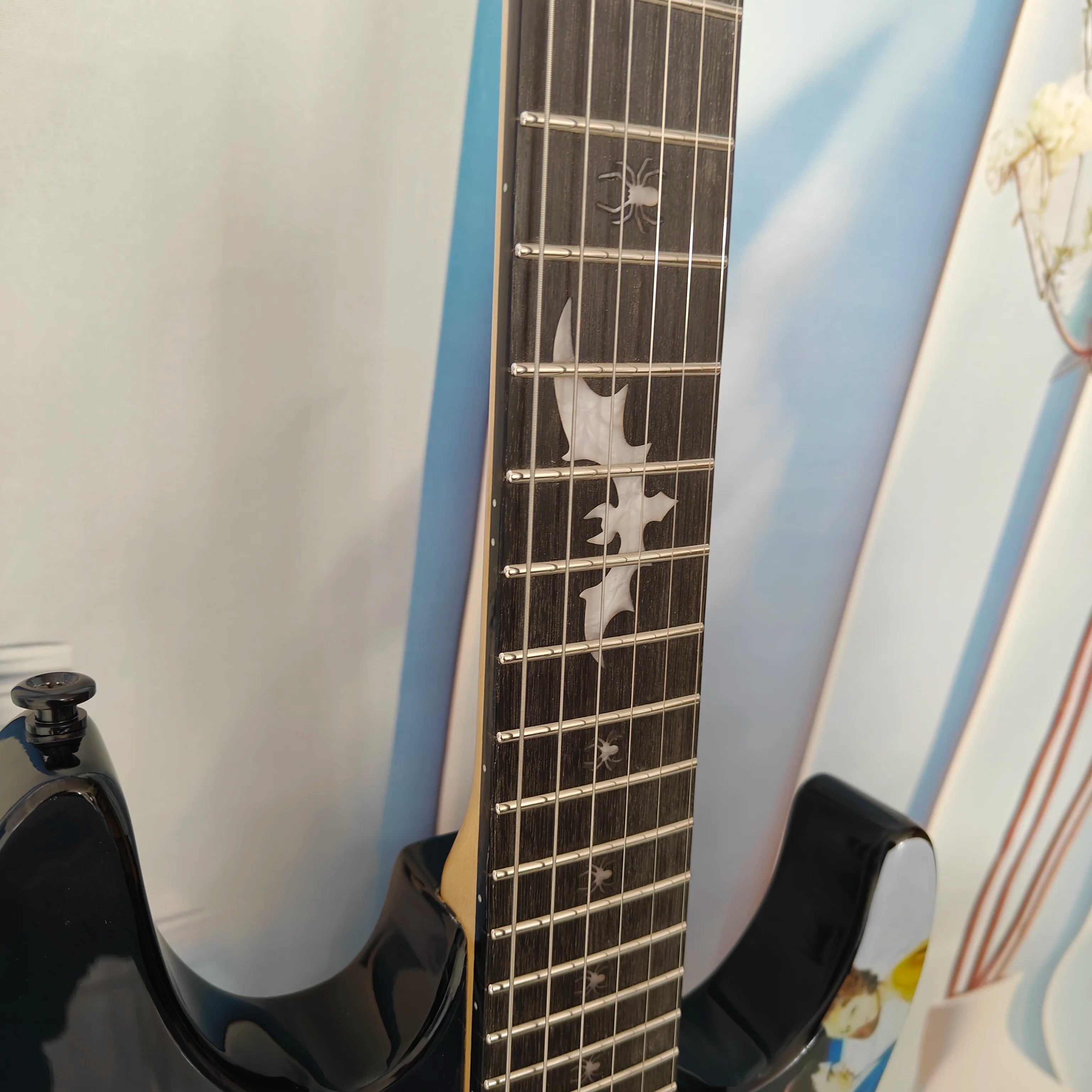 A high-quality acoustic electric guitar with solid wood body, body decals, rock style, right-hand playing and stainless steel fr